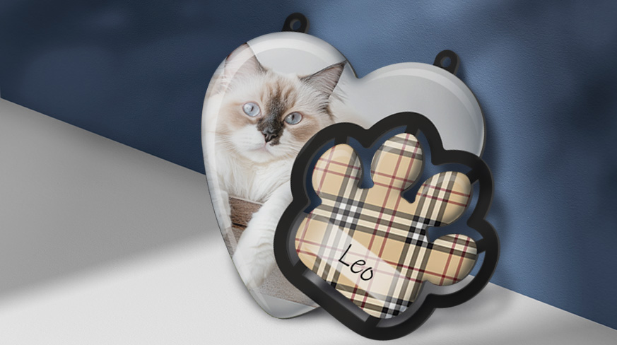 Heart-shaped cat photo tag with plaid paw tag labeled “Leo” — personalized pet ornament on blue background.
