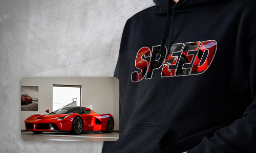 Person in black hoodie with SPEED text, letters filled with red Ferrari graphic, inset image shows Ferrari in showroom