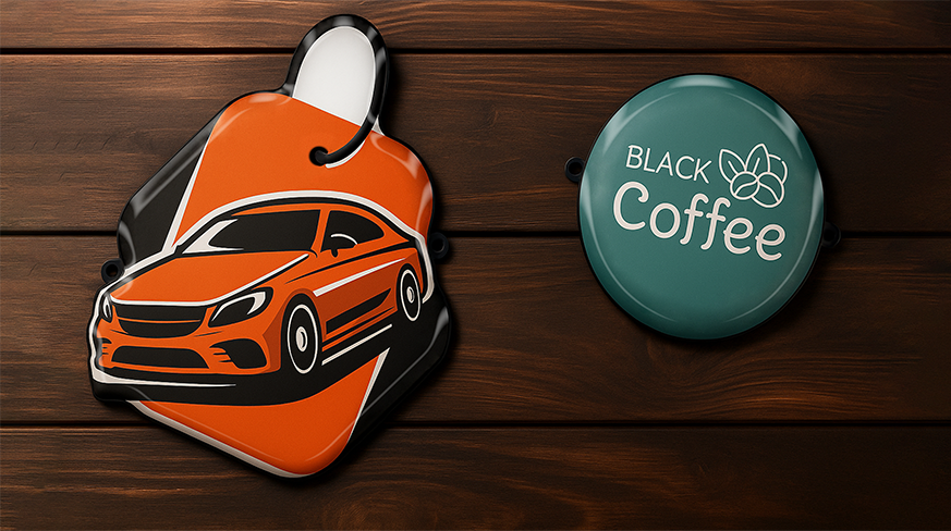 Two keychain tags - orange sports car illustration on hexagon and “BLACK Coffee” logo on teal circle.