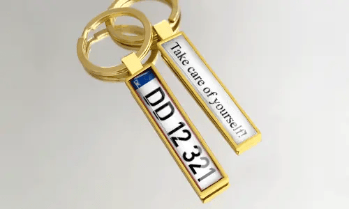 I portachiavi in metallo dorato presentano design di targhe personalizzate e testo inciso