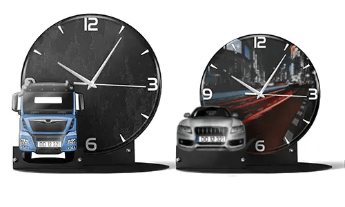 Two decorative clocks with model vehicles: left with black marble face and blue truck, right with cityscape and red sports car