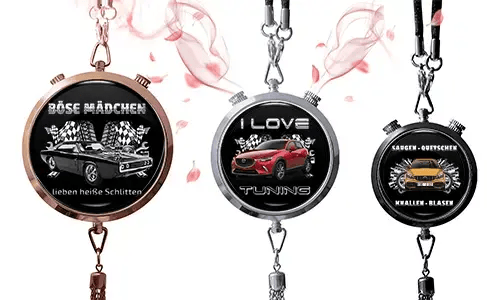 Three round pendants with car themes on black backgrounds. Left: vintage car with German text and checkered flags. Center: red SUV, 