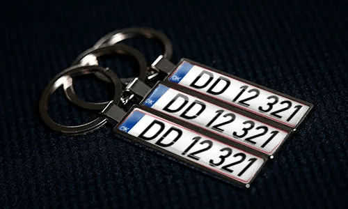Personalized keychains feature license plate designs with custom numbering