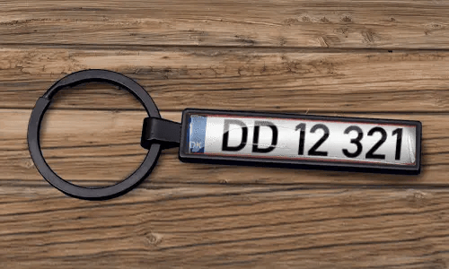 Custom license plate keychain appears with a matte black finish