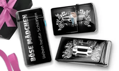 Three shiny black objects with car-themed designs. One reads 