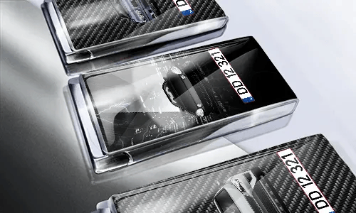 Three car-themed boxes with glossy finish: silver with car, black with cityscape and black car, red with car front